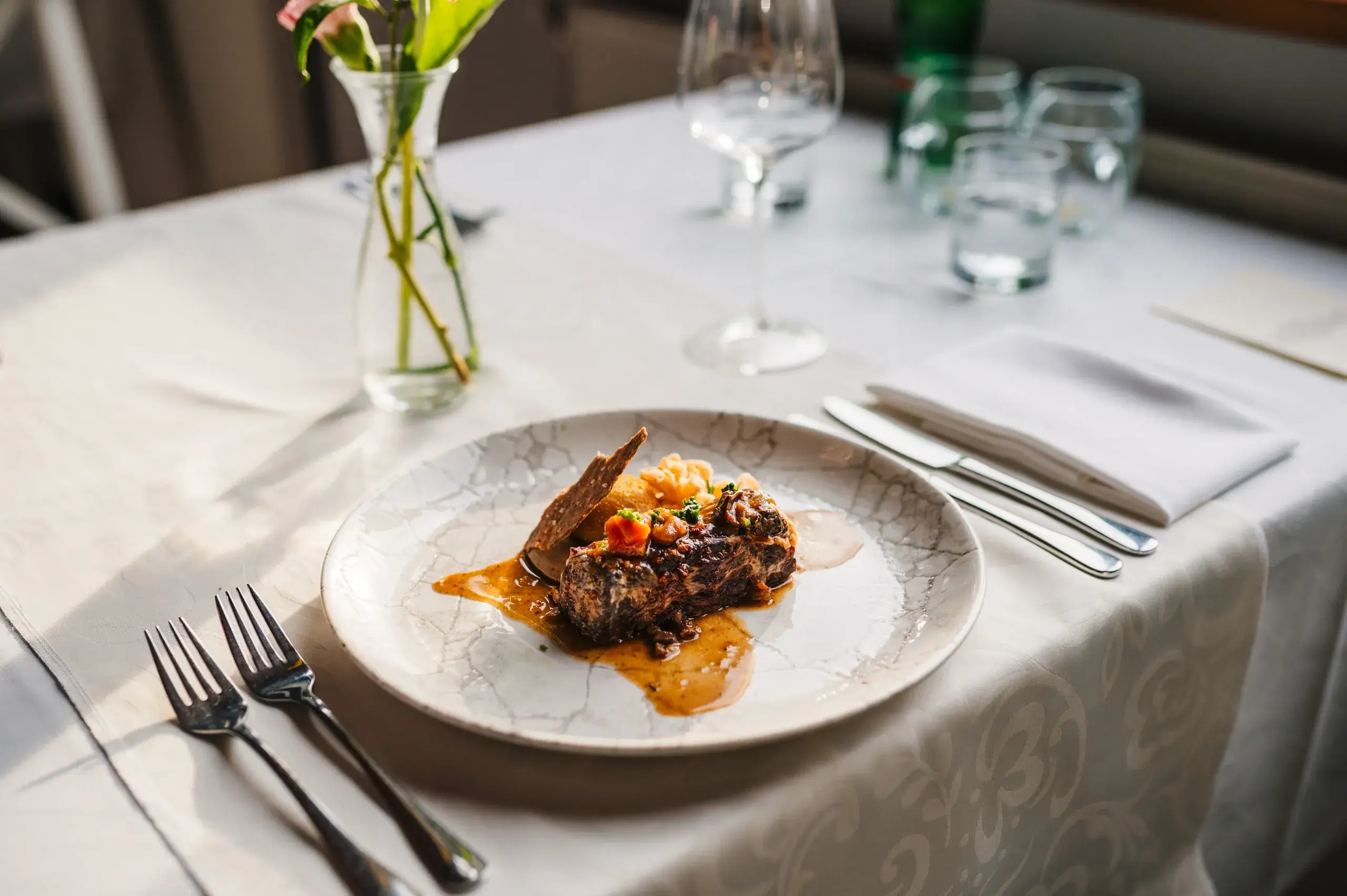 A finished plate at a fine dining table